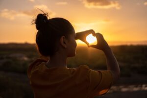 woman doing hand heart sign