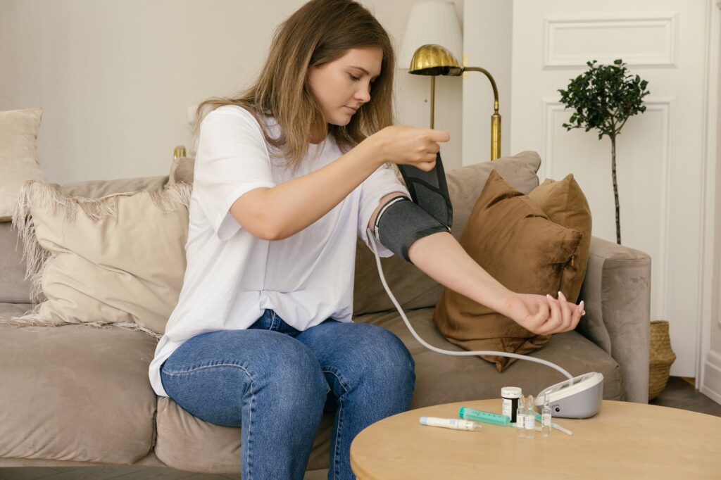 a woman in white shirt checking her blood pressure
